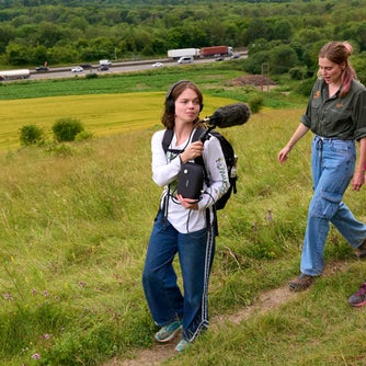 A ranger, a sound recordist and an interviewer recording a podcast on Oxted Downs overlooking the M25